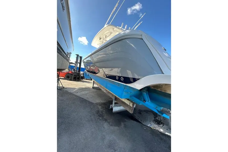 Slide: The Image of 2014 Intrepid 327 Center Console boat on dry dock under clear blue sky. - 6