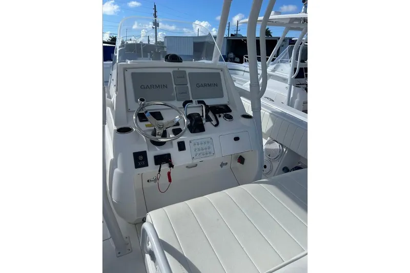 Slide: The Image of 2014 Intrepid 327 Center Console boat dashboard with Garmin navigation systems. - 7