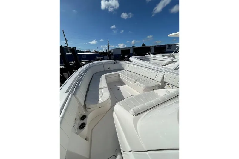 Slide: The Image of 2014 Intrepid 327 Center Console boat with spacious seating under a clear blue sky. - 9