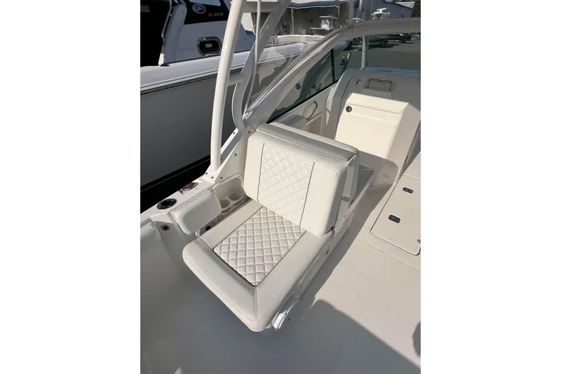 Slide: The Image of 2024 Pursuit DC 246 Dual Console boat interior with white quilted seating. - 10