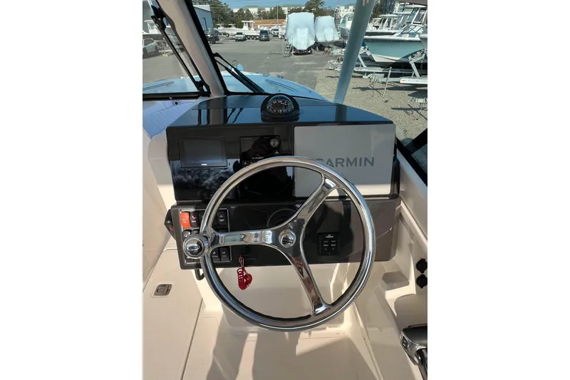 Slide: The Image of 2024 Pursuit DC 246 Dual Console boat helm with Garmin navigation system. - 11