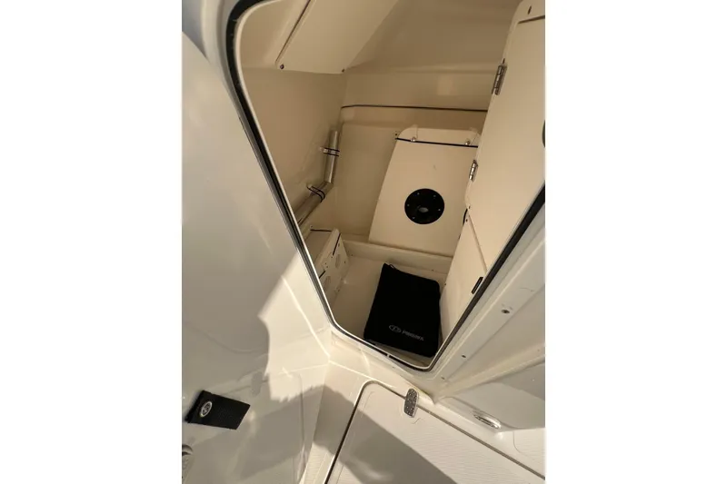 Slide: The Image of 2024 Pursuit DC 246 Dual Console interior cabin view, showcasing sleek design and storage space. - 14
