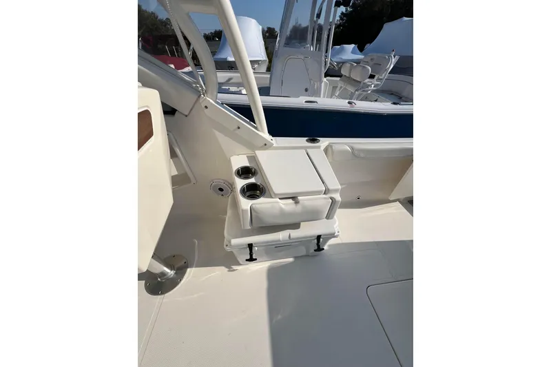 Slide: The Image of 2024 Pursuit DC 246 Dual Console boat interior with seating and cup holders. - 15