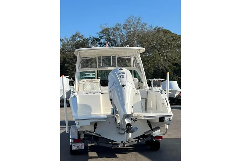 Slide: The Image of 2024 Pursuit DC 246 Dual Console boat with Yamaha 300 engine, parked outdoors. - 8