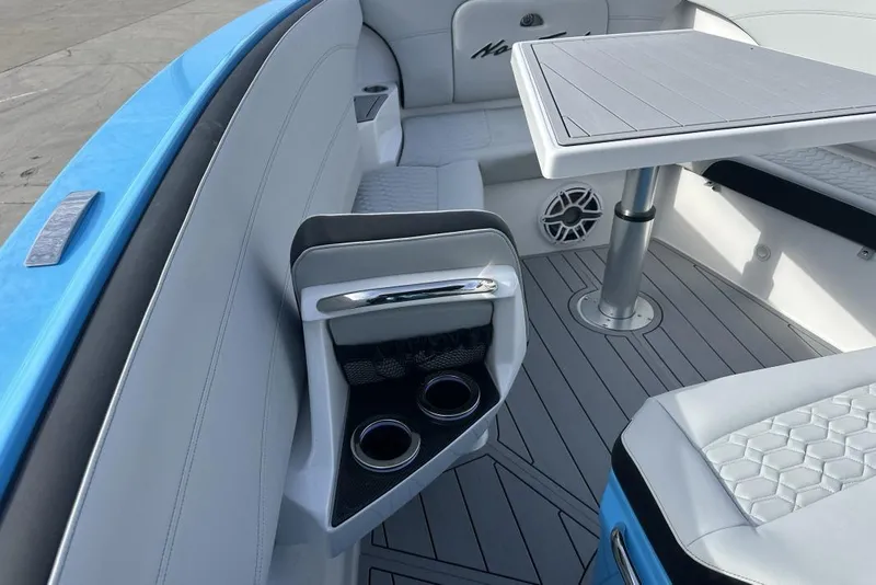 Slide: The Image of 2025 Nor-Tech 340 Sport Center Console interior with seating, table, and cup holders. - 11