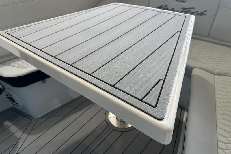 Slide: The Image of 2025 Nor-Tech 340 Sport Center Console interior with sleek table design. - 12