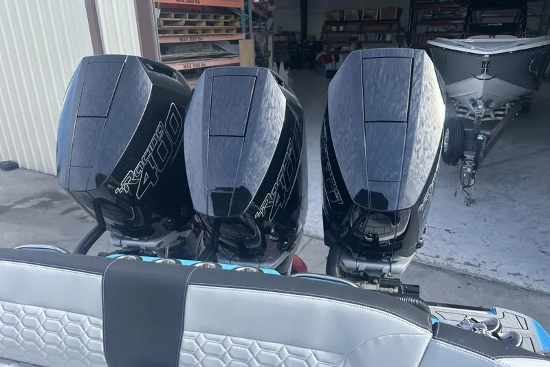 Slide: The Image of 2025 Nor-Tech 340 Sport Center Console with triple Mercury Racing 400 engines in a garage. - 14
