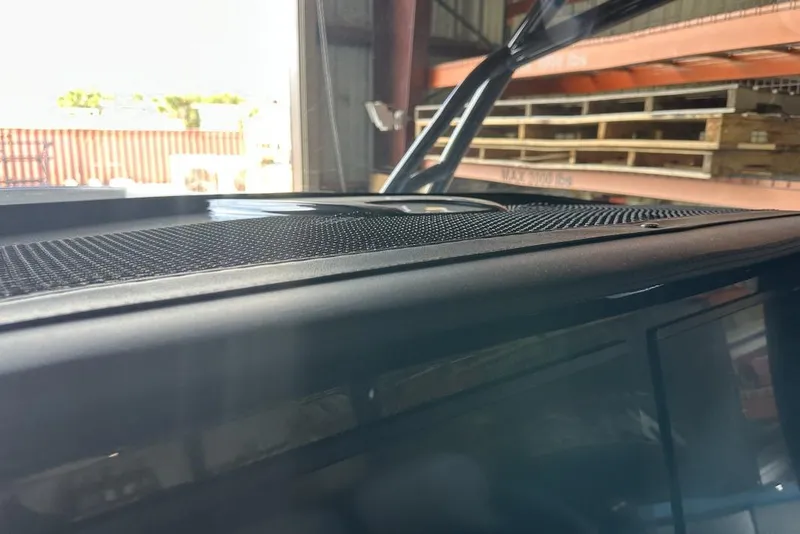 Slide: The Image of 2025 Nor-Tech 340 Sport Center Console dashboard detail in a warehouse setting. - 15