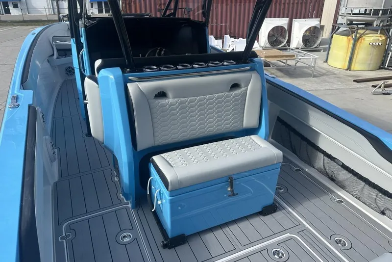 Slide: The Image of 2025 Nor-Tech 340 Sport Center Console boat interior with blue and gray seating. - 22
