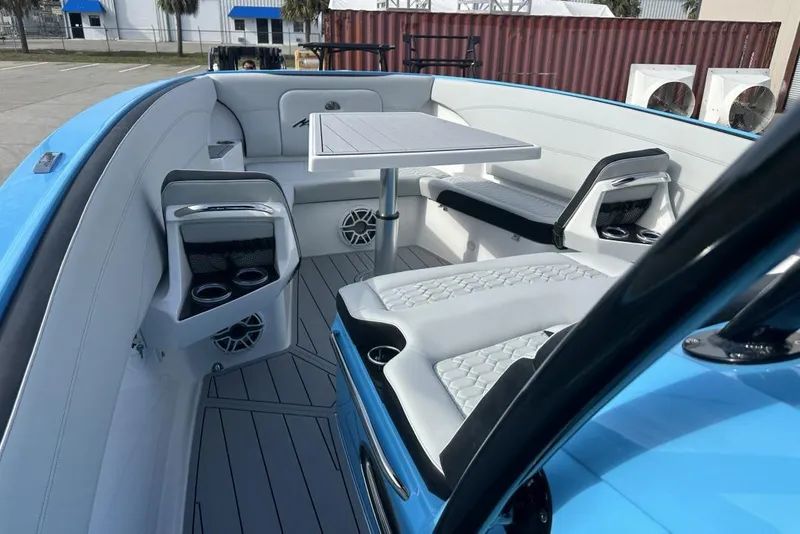 Slide: The Image of 2025 Nor-Tech 340 Sport Center Console interior with seating and table, featuring modern design. - 25