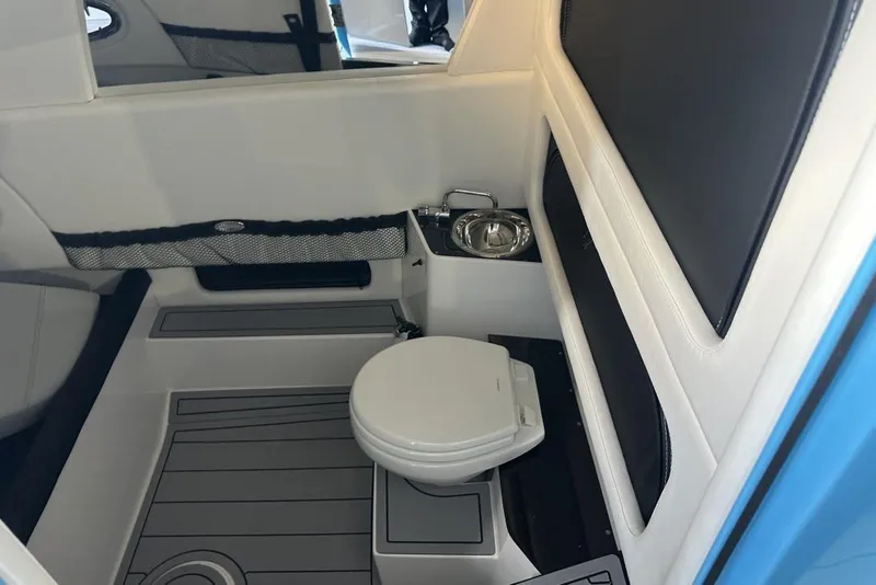 Slide: The Image of 2025 Nor-Tech 340 Sport Center Console interior with toilet and sink. - 27