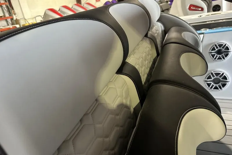 Slide: The Image of 2025 Nor-Tech 340 Sport Center Console interior seating with stylish upholstery and speaker system. - 28