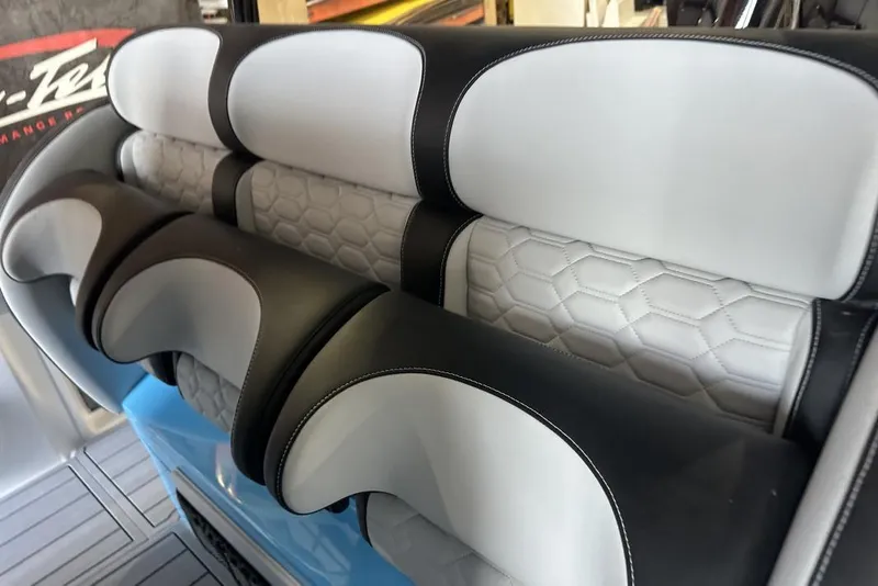 Slide: The Image of 2025 Nor-Tech 340 Sport Center Console interior with stylish, hexagonal-patterned seating. - 31