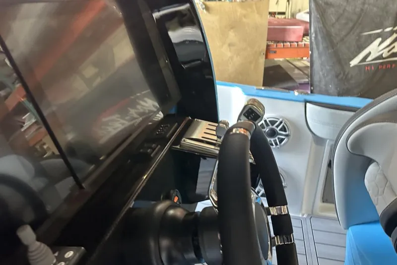 Slide: The Image of 2025 Nor-Tech 340 Sport Center Console interior with steering wheel and control panel. - 32