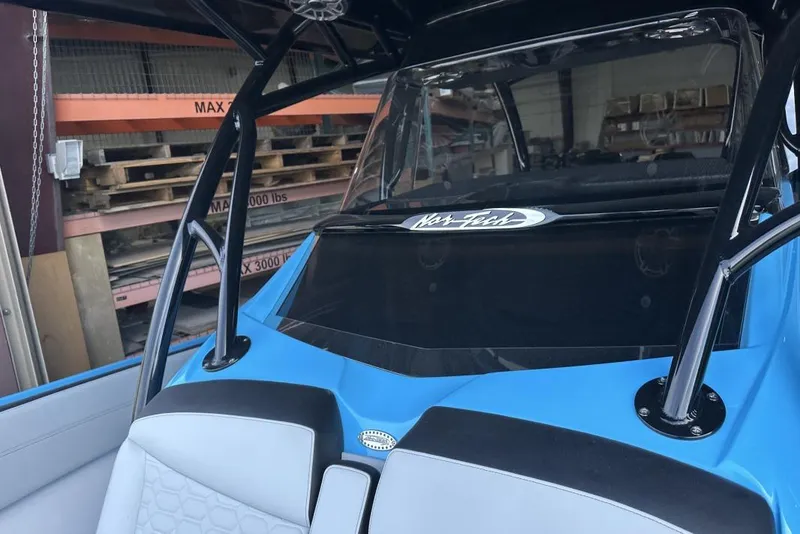 Slide: The Image of 2025 Nor-Tech 340 Sport Center Console boat interior with blue and gray seating. - 34
