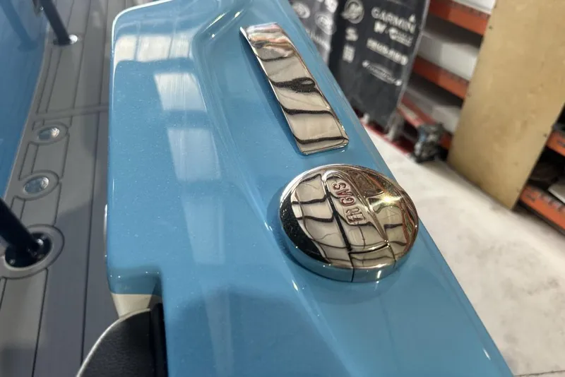 Slide: The Image of 2025 Nor-Tech 340 Sport Center Console, blue exterior with chrome gas cap detail. - 35