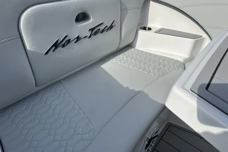 Slide: The Image of 2025 Nor-Tech 340 Sport Center Console interior with elegant white seating and embossed logo. - 5