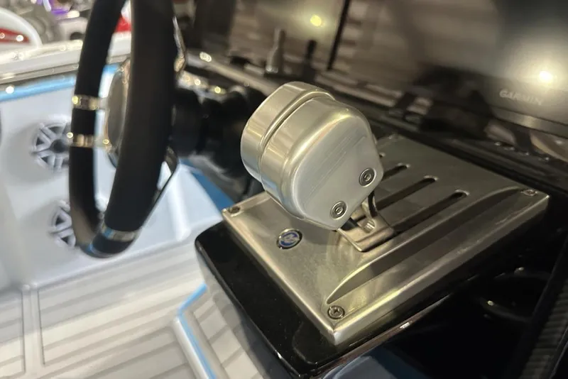 Slide: The Image of 2025 Nor-Tech 340 Sport Center Console helm with steering wheel and throttle controls. - 6
