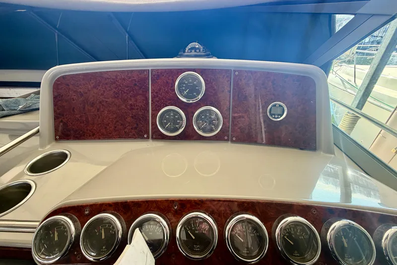 Slide: The Image of Dashboard of a 2002 Formula 37 Performance Cruiser with multiple gauges and wood paneling. - 19