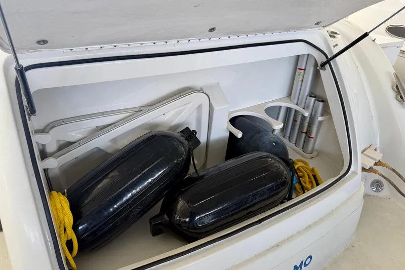 Slide: The Image of Open storage compartment on 2002 Formula 37 Performance Cruiser with fenders and ropes. - 6