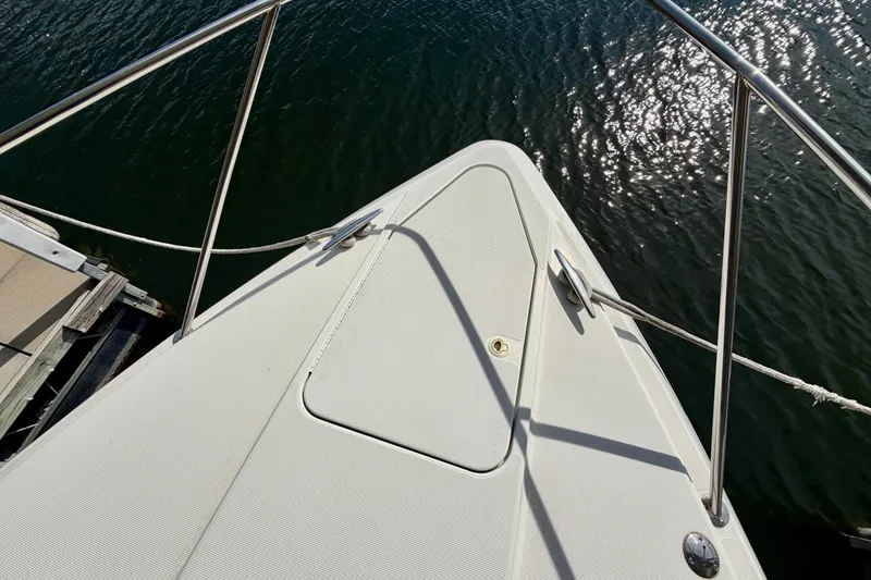 Slide: The Image of Bow of 2002 Formula 37 Performance Cruiser on water, with sunlight reflections. - 9