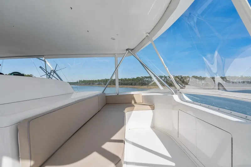 Slide: The Image of Interior view of 2002 Viking 61 Convertible yacht with spacious seating and panoramic windows. - 13