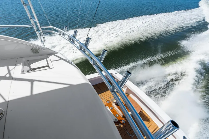 Slide: The Image of 2002 Viking 61 Convertible yacht cruising on open water, leaving a wake. - 15