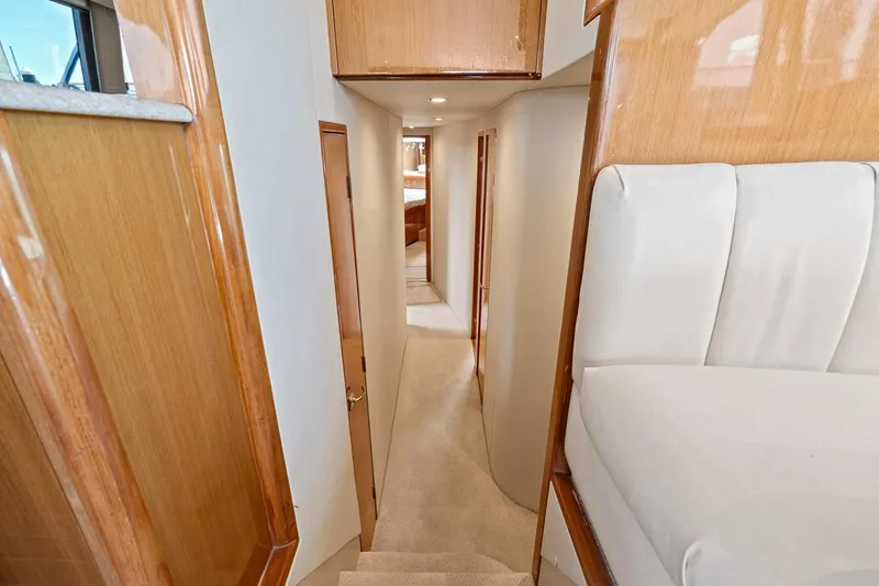 Slide: The Image of Interior hallway of 2002 Viking 61 Convertible yacht with wooden finishes. - 31