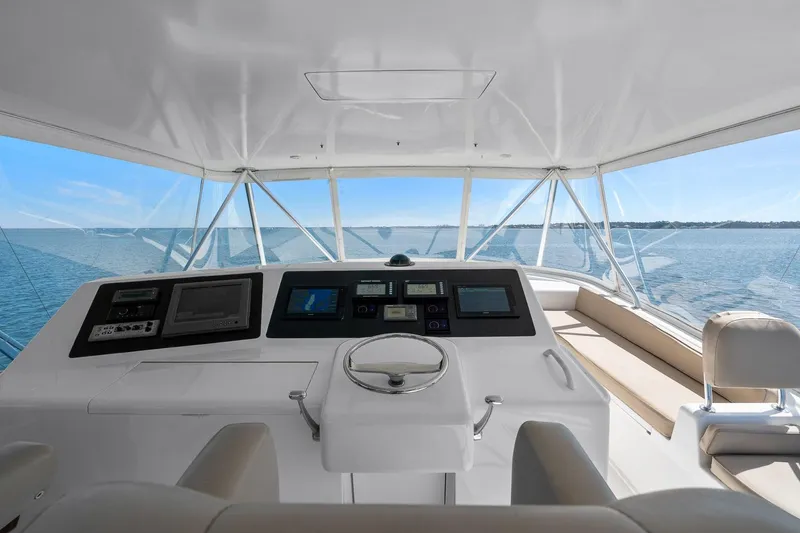 Slide: The Image of Helm of 2002 Viking 61 Convertible yacht with ocean view and navigation equipment. - 35