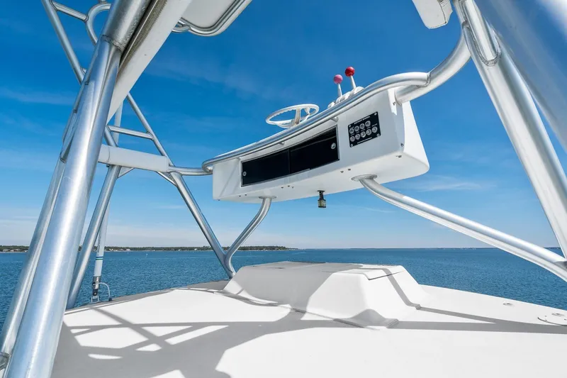 Slide: The Image of 2002 Viking 61 Convertible yacht helm with ocean view and clear blue sky. - 38
