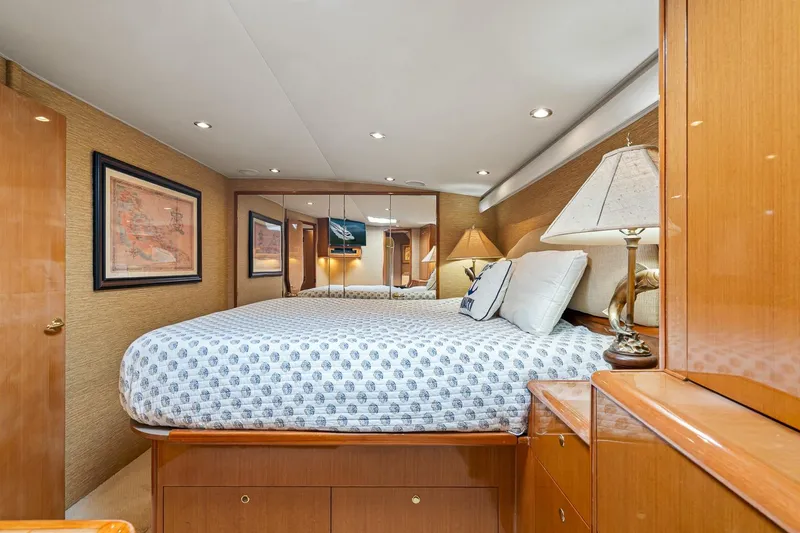 Slide: The Image of Luxurious bedroom interior of 2002 Viking 61 Convertible yacht with elegant wood finishes. - 46