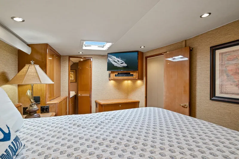 Slide: The Image of Luxurious bedroom interior of 2002 Viking 61 Convertible yacht with elegant wood finishes. - 47