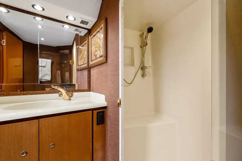 Slide: The Image of Luxurious bathroom in 2002 Viking 61 Convertible yacht with elegant fixtures and shower. - 49