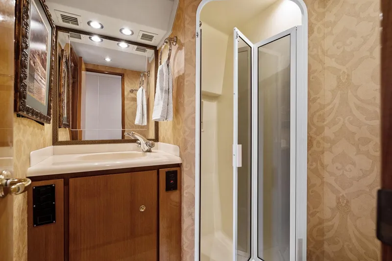 Slide: The Image of Luxurious bathroom in 2002 Viking 61 Convertible yacht with elegant wood cabinetry and shower. - 50