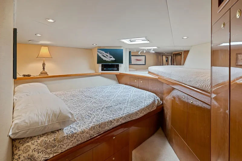 Slide: The Image of Luxurious cabin interior of 2002 Viking 61 Convertible yacht with cozy bedding and elegant decor. - 52
