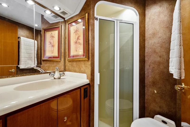 Slide: The Image of Luxurious bathroom in 2002 Viking 61 Convertible yacht with elegant decor and modern fixtures. - 56