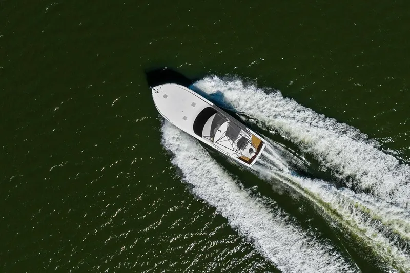 Slide: The Image of Aerial view of 2002 Viking 61 Convertible yacht cruising on open water. - 63