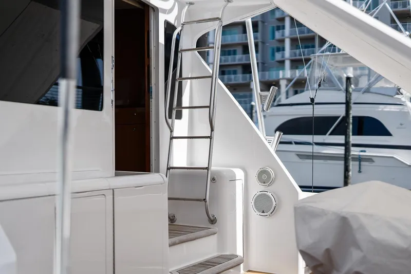 Slide: The Image of 2002 Viking 61 Convertible yacht with ladder and marina view. - 7