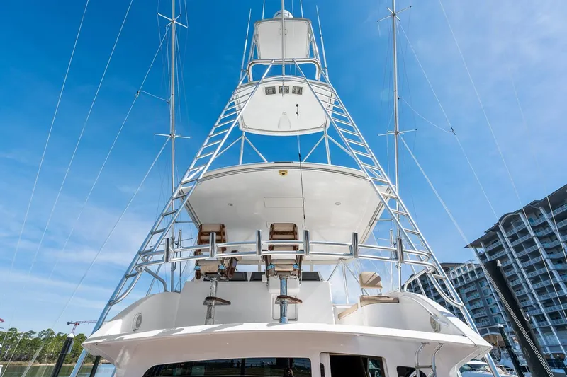 Slide: The Image of 2002 Viking 61 Convertible yacht with tall tower against blue sky. - 8