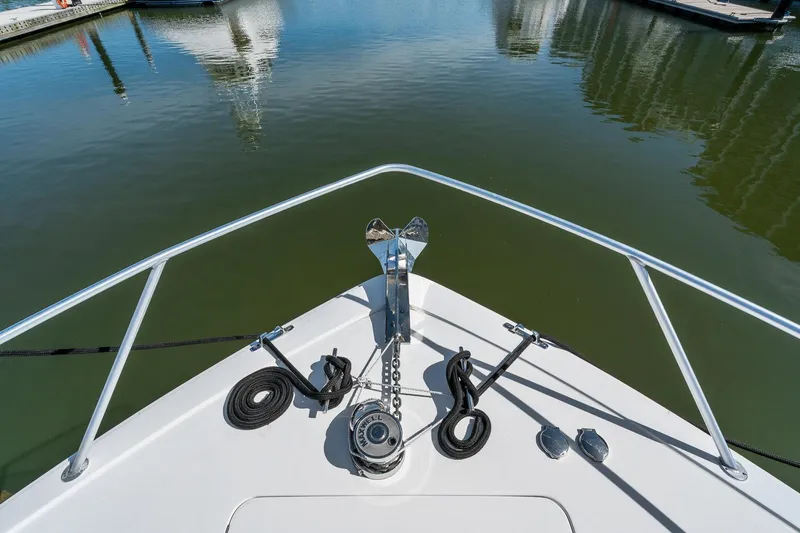 Slide: The Image of Bow of 2002 Viking 61 Convertible yacht with anchor and ropes in marina. - 9