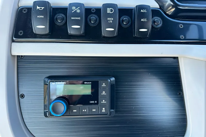 Slide: The Image of Control panel of 2026 Sweetwater 2286 QS with Clarion audio system and switches. - 10