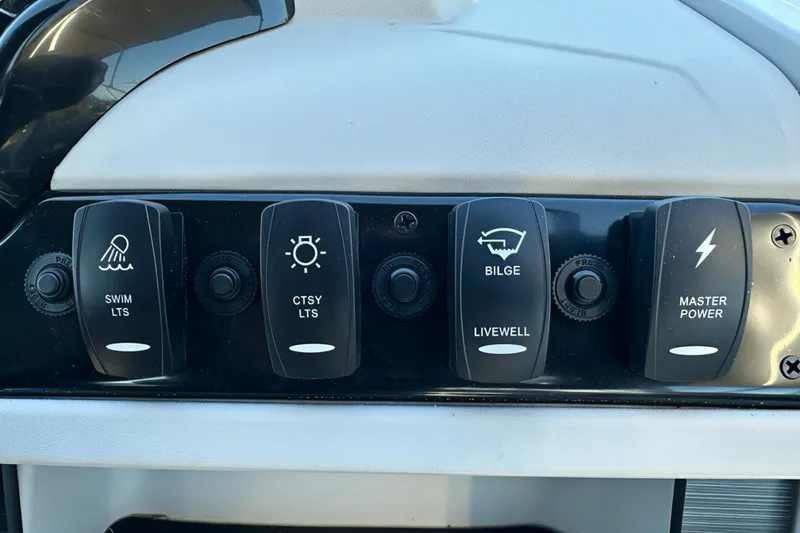 Slide: The Image of Control panel of 2026 Sweetwater 2286 QS boat with labeled switches for various functions. - 11