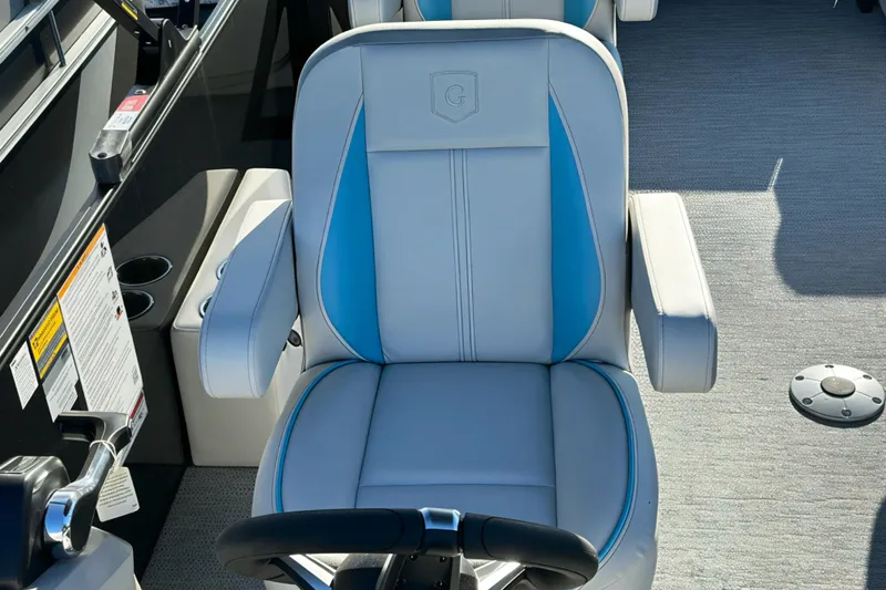 Slide: The Image of Captain's chair on 2026 Sweetwater 2286 QS boat, featuring blue accents and armrests. - 13