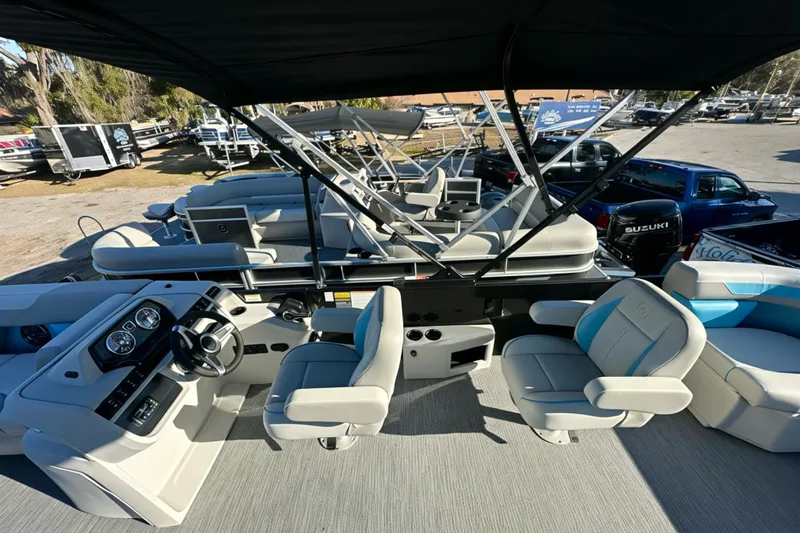 Slide: The Image of 2026 Sweetwater 2286 QS pontoon boat interior with seating and steering console. - 15