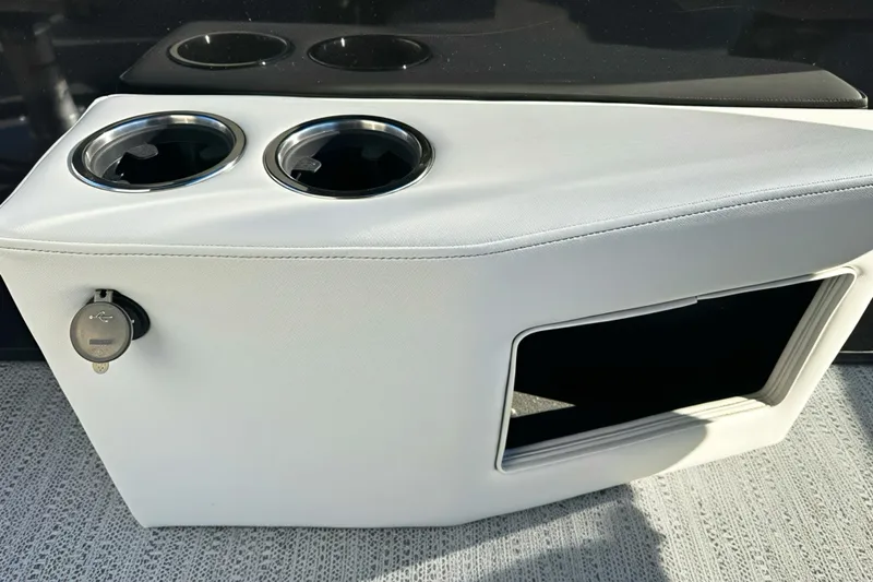 Slide: The Image of 2026 Sweetwater 2286 QS boat console with cup holders and USB port. - 16