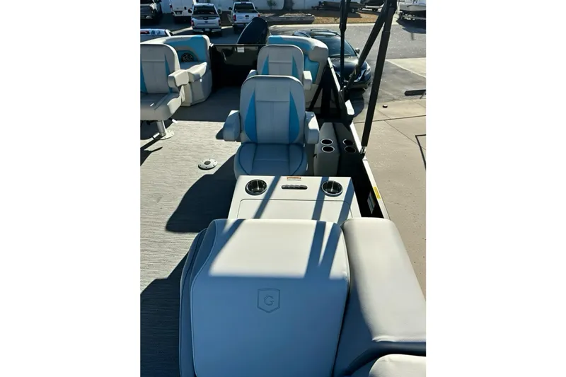 Slide: The Image of 2026 Sweetwater 2286 QS boat interior with plush seating and cup holders. - 21