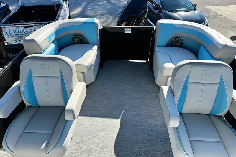 Slide: The Image of 2026 Sweetwater 2286 QS boat interior with blue and white seating, featuring modern design. - 29