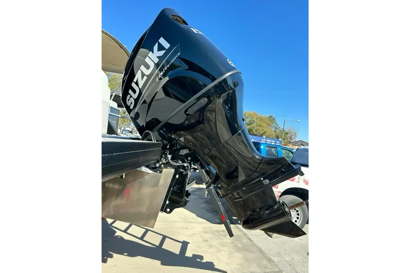 Slide: The Image of Suzuki outboard motor on 2026 Sweetwater 2286 QS boat, parked outdoors. - 35