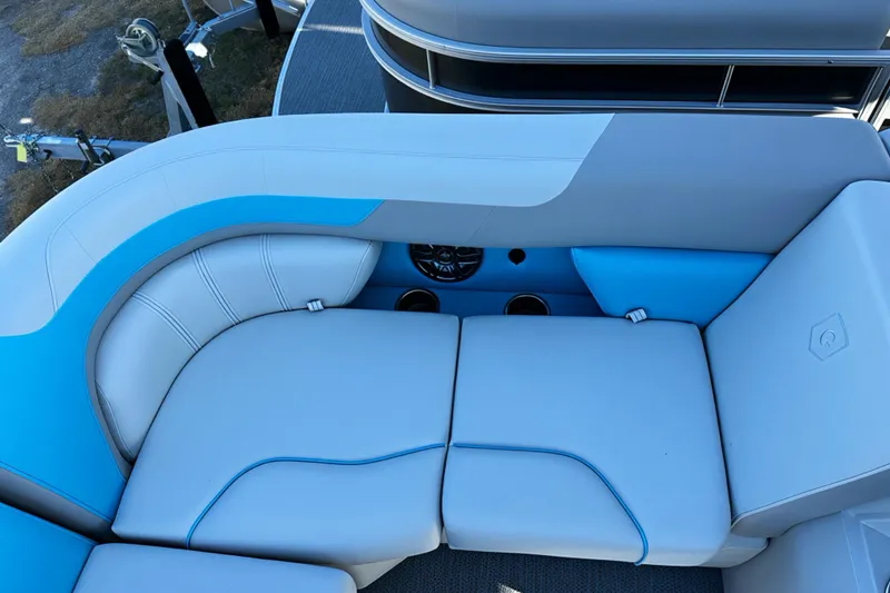 Slide: The Image of Luxurious seating on 2026 Sweetwater 2286 QS pontoon boat, featuring blue and white upholstery. - 4