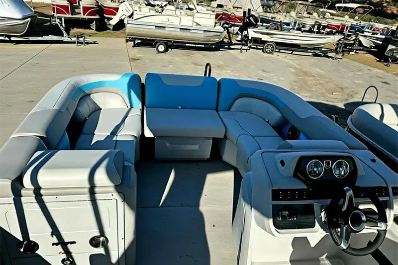 Slide: The Image of 2026 Sweetwater 2286 QS pontoon boat interior with plush seating and modern dashboard. - 7